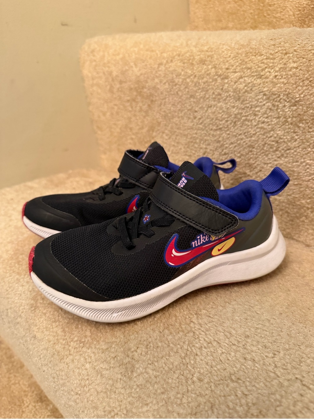 Nike Black Kids' Sneakers with Purple Lining and Red Accent